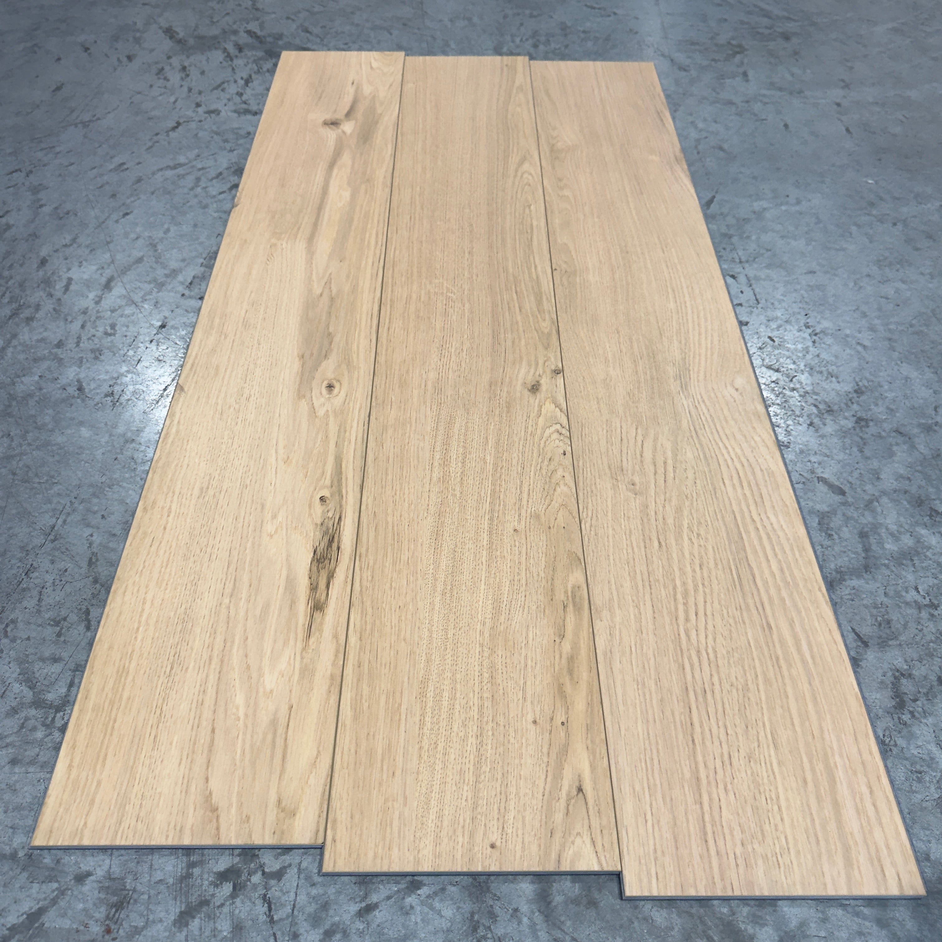 Mohawk LVP Flooring 465 - 5MM - Three planks fanned showing warm honey-beige oak grain with bold cathedral pattern