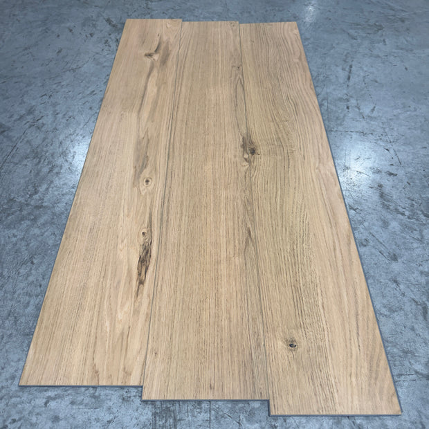 Mohawk LVP Flooring 567 - 5MM - Three planks fanned showing medium warm-tan oak grain with flowing lines and knots