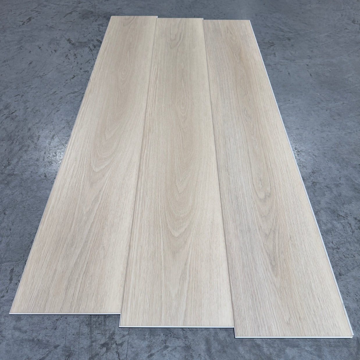 Toucan SPC Flooring 512 - 6MM - Three planks showing soft whitewashed linen oak grain with fine flowing figure